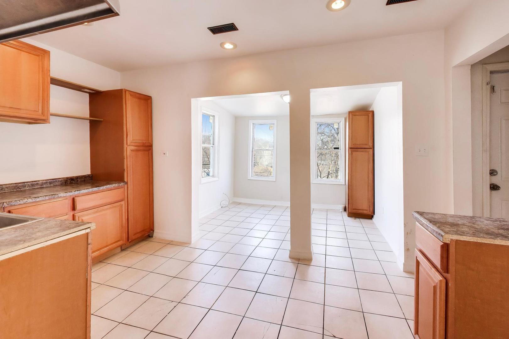 6853 South Perry Avenue Chicago, IL 60621 - Photo 15 of 28 a view of a kitchen cabinets and wooden floor