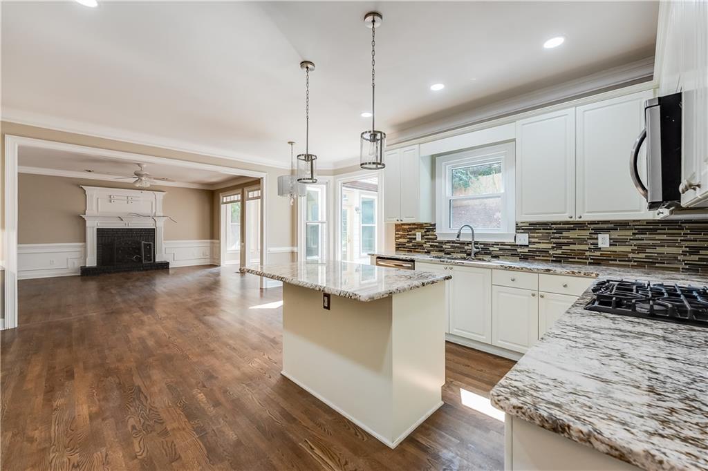 5719 Brookstone Walk Northwest Acworth, GA 30101 - Photo 11 of 54 a large kitchen with kitchen island a stove a sink a refrigerator and chandelier