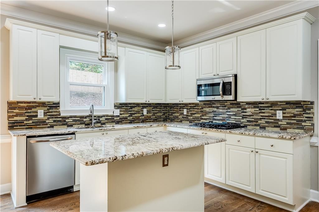 5719 Brookstone Walk Northwest Acworth, GA 30101 - Photo 12 of 54 a kitchen with stainless steel appliances granite countertop a sink and a stove