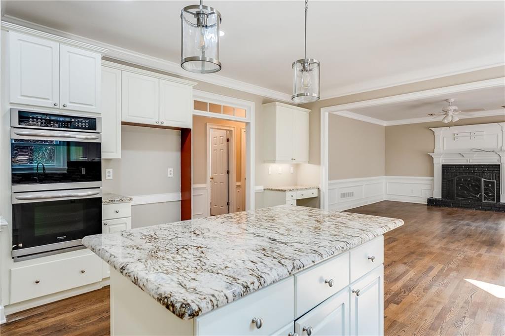 5719 Brookstone Walk Northwest Acworth, GA 30101 - Photo 14 of 54 a kitchen with kitchen island granite countertop a sink appliances and cabinets