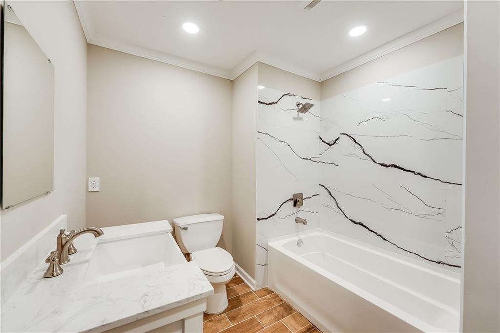 5719 Brookstone Walk Northwest Acworth, GA 30101 - Photo 34 of 54 a bathroom with a sink a toilet and a bathtub