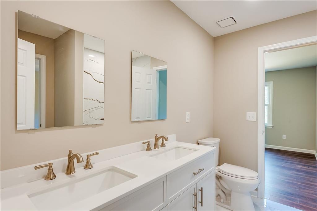 5719 Brookstone Walk Northwest Acworth, GA 30101 - Photo 40 of 54 a bathroom with a sink toilet and a mirror