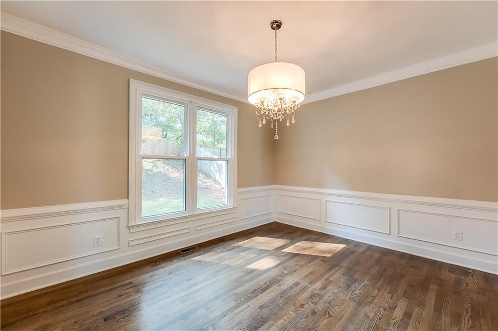 5719 Brookstone Walk Northwest Acworth, GA 30101 - Photo 9 of 54 a view of an empty room with a window and chandelier