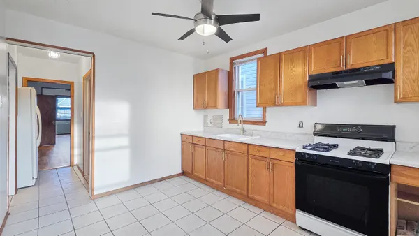 a kitchen with stainless steel appliances a stove sink and cabinets