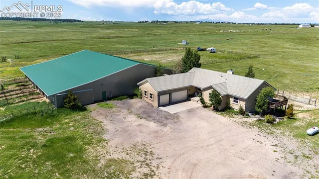 an aerial view of a house with garden space and ocean view