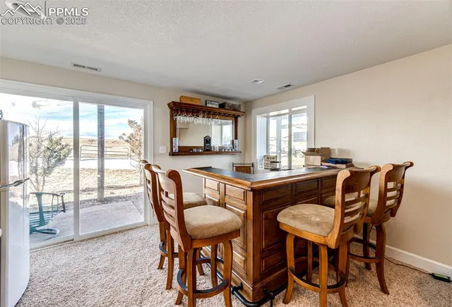 a view of a dining room with furniture window and outside view