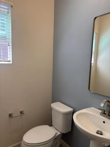 a white toilet sitting next to a bathroom sink