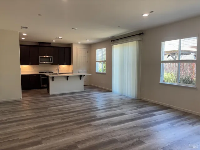 a view of kitchen with wooden floor and electronic appliances