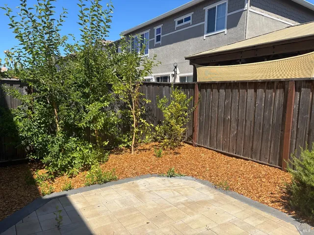 a view of a house with a flower garden