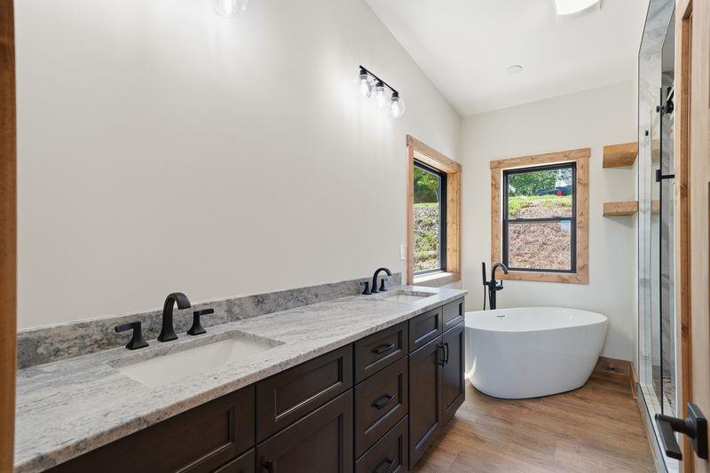 216 Old Orchard Road Ellijay, GA 30536 - Photo 22 of 59 a spacious bathroom with a granite countertop sink and a bathtub