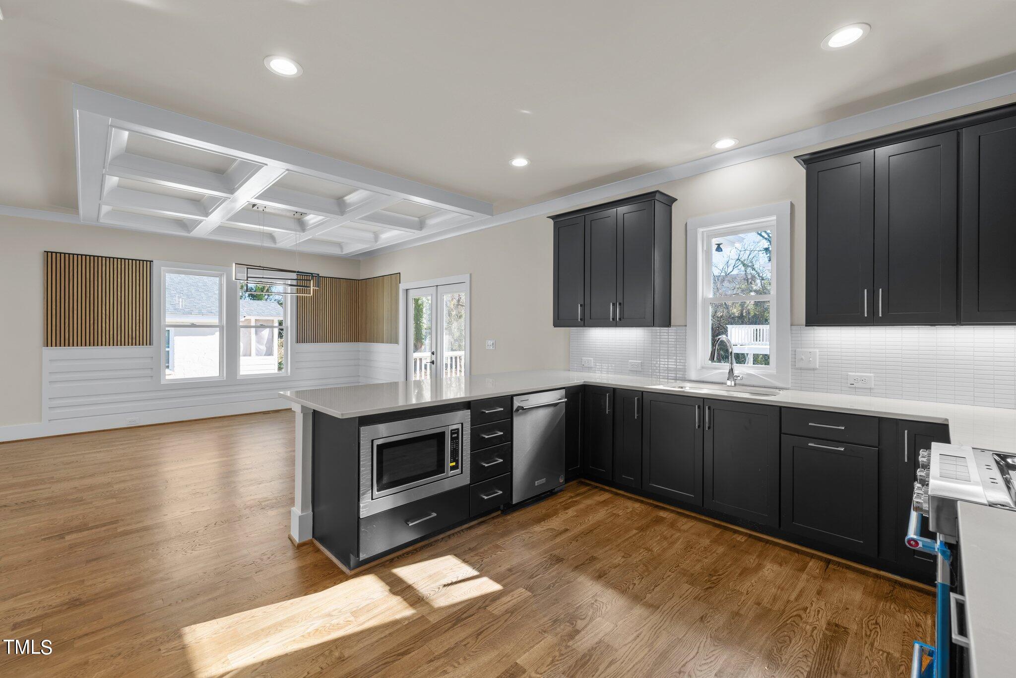 600 Bragg Street Raleigh, NC 27610 - Photo 11 of 68 a kitchen with stainless steel appliances granite countertop a stove a sink and a microwave