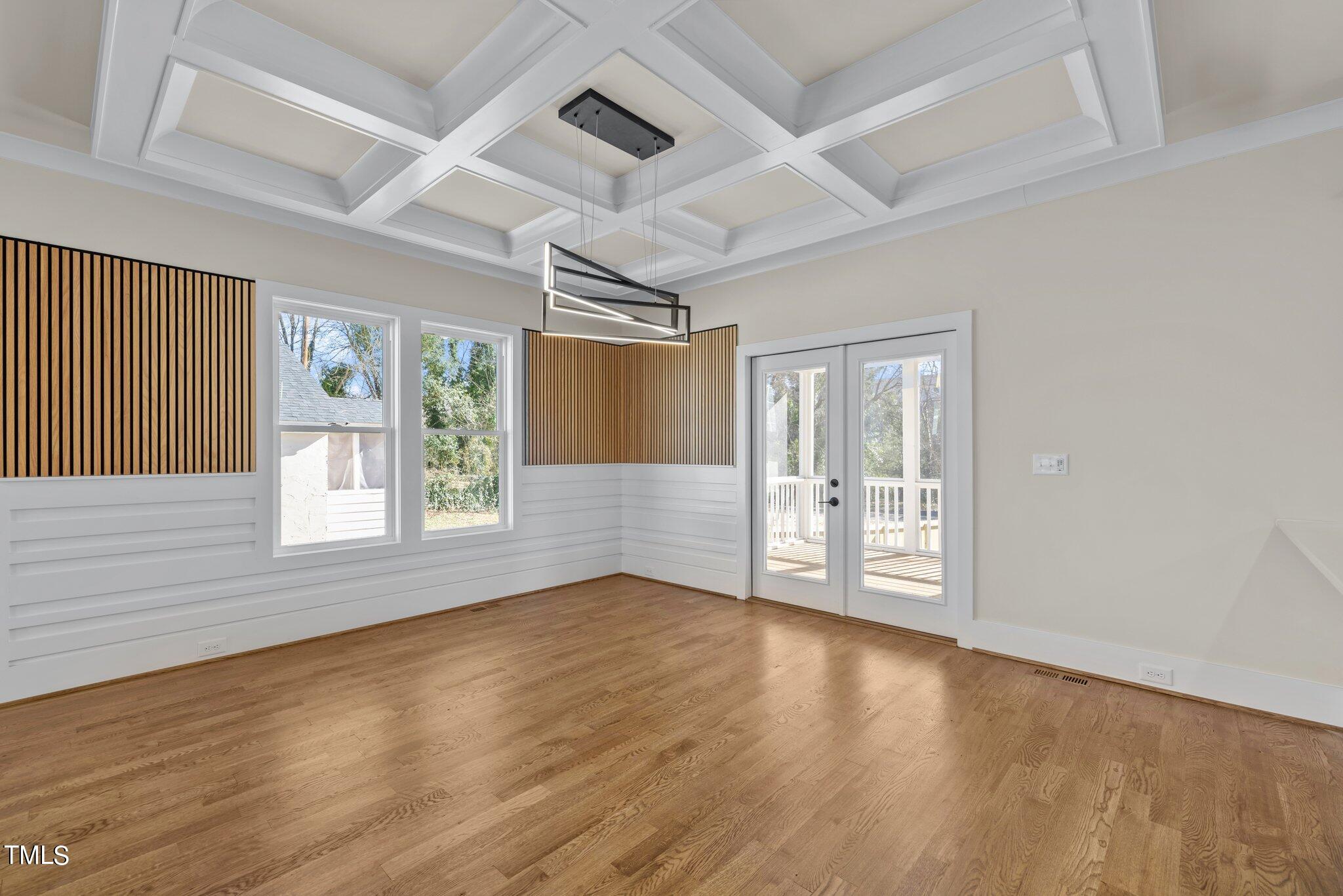 600 Bragg Street Raleigh, NC 27610 - Photo 18 of 68 an empty room with wooden floor and windows