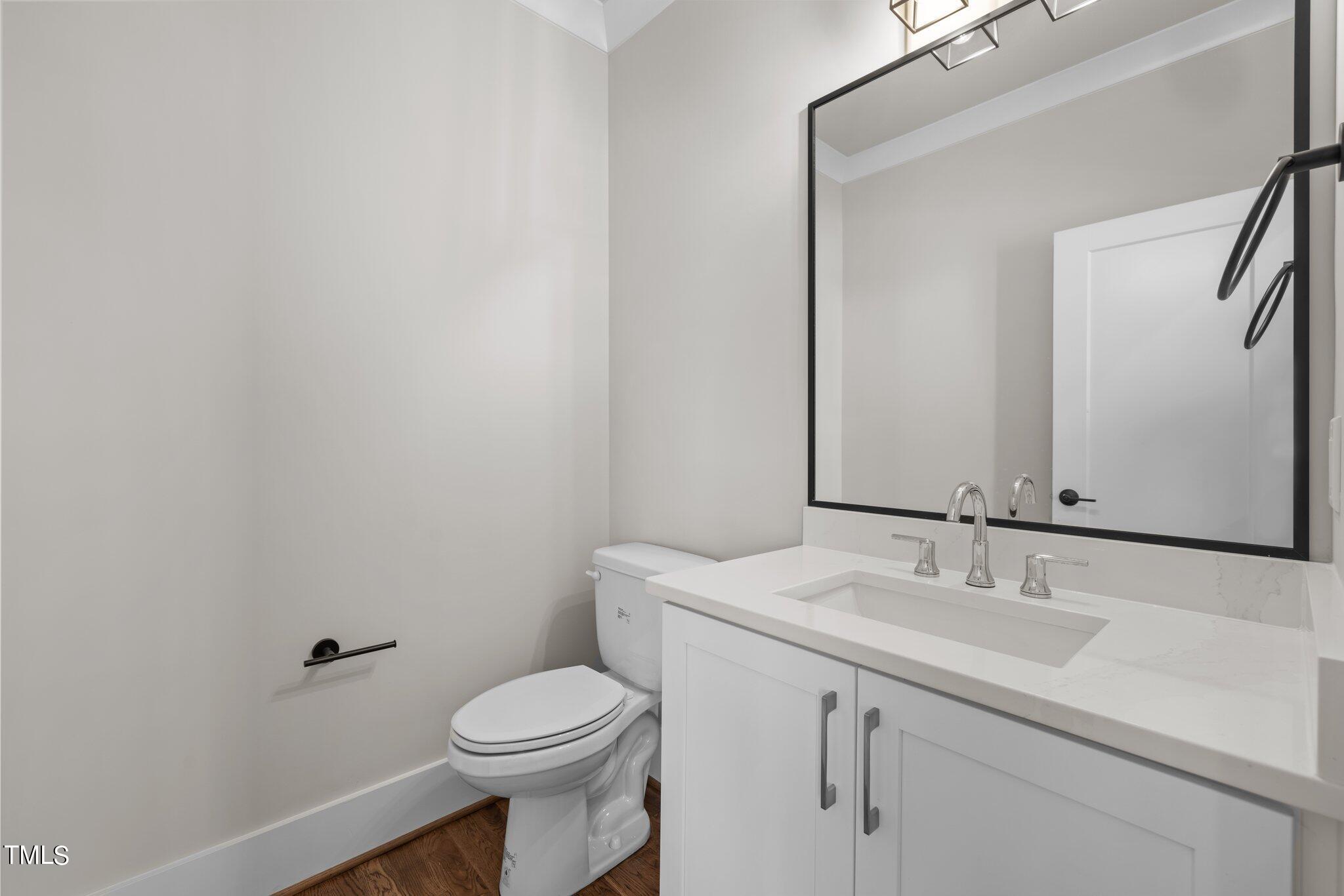 600 Bragg Street Raleigh, NC 27610 - Photo 21 of 68 a bathroom with a sink a toilet and mirror
