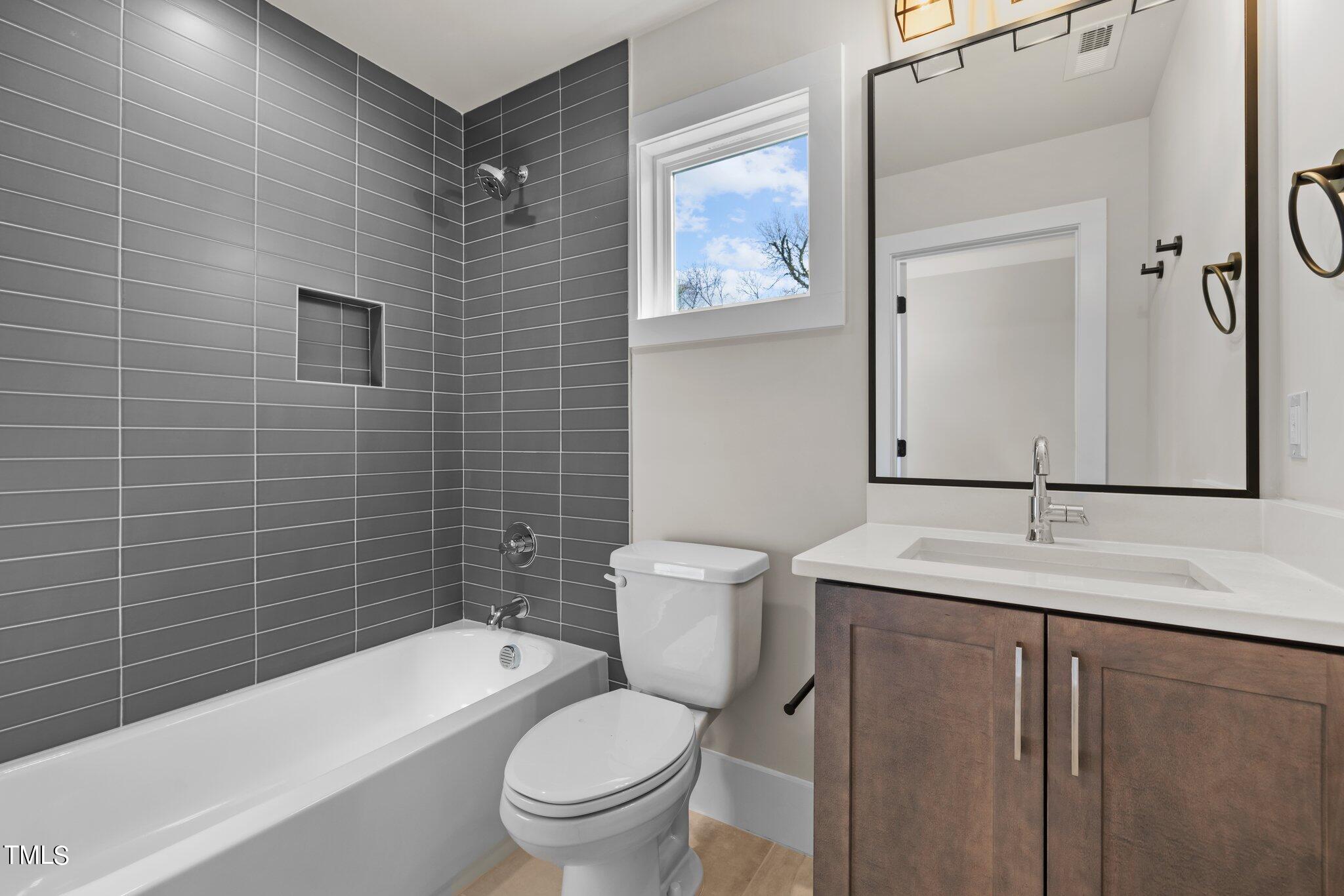 600 Bragg Street Raleigh, NC 27610 - Photo 24 of 68 a bathroom with a sink a toilet and shower