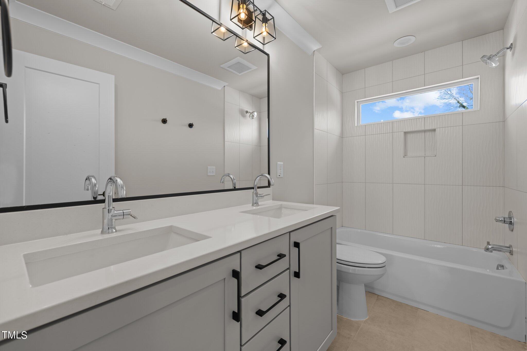 600 Bragg Street Raleigh, NC 27610 - Photo 33 of 68 a bathroom with a granite countertop sink a toilet and bathtub