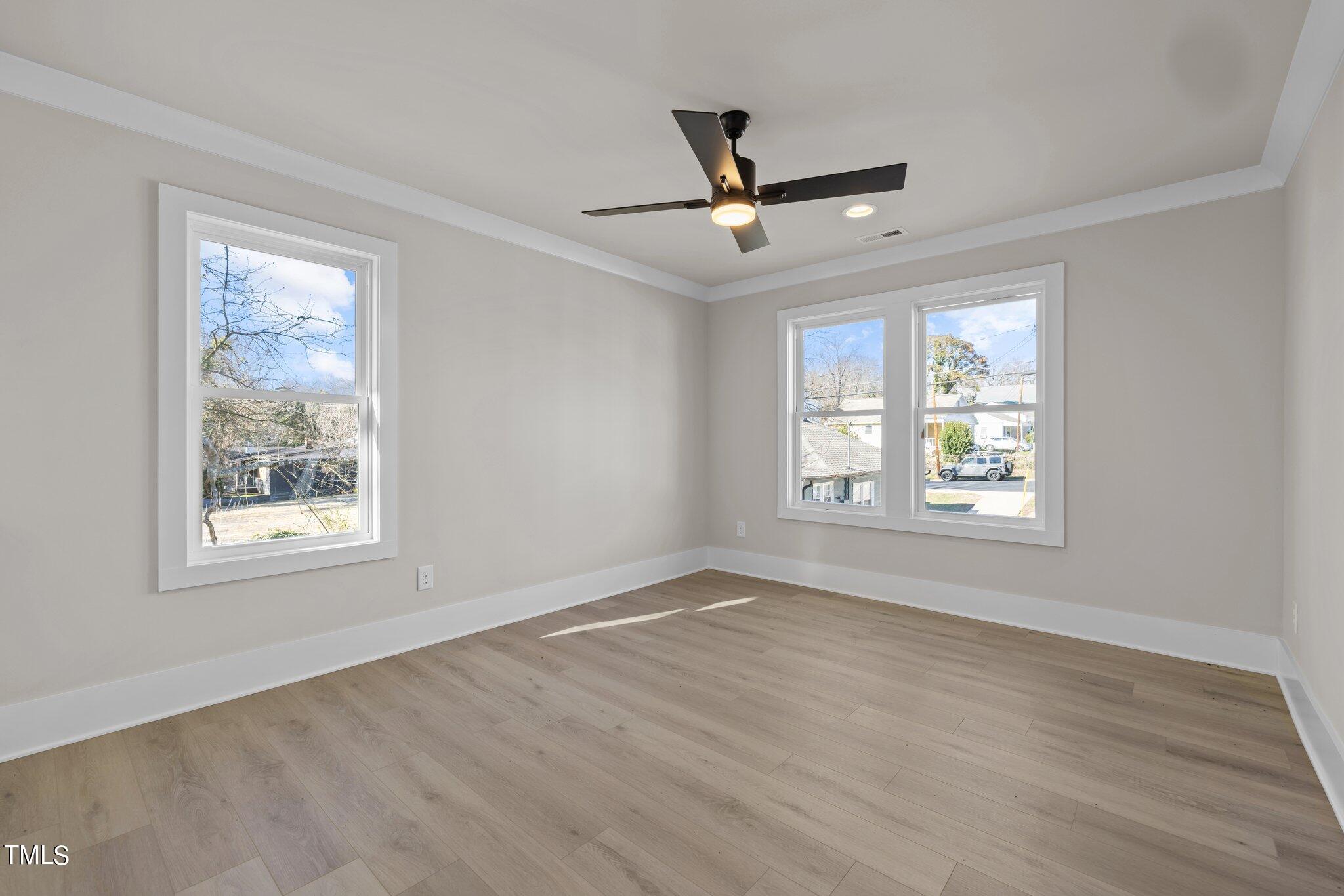 600 Bragg Street Raleigh, NC 27610 - Photo 35 of 68 a view of an empty room with wooden floor and a window