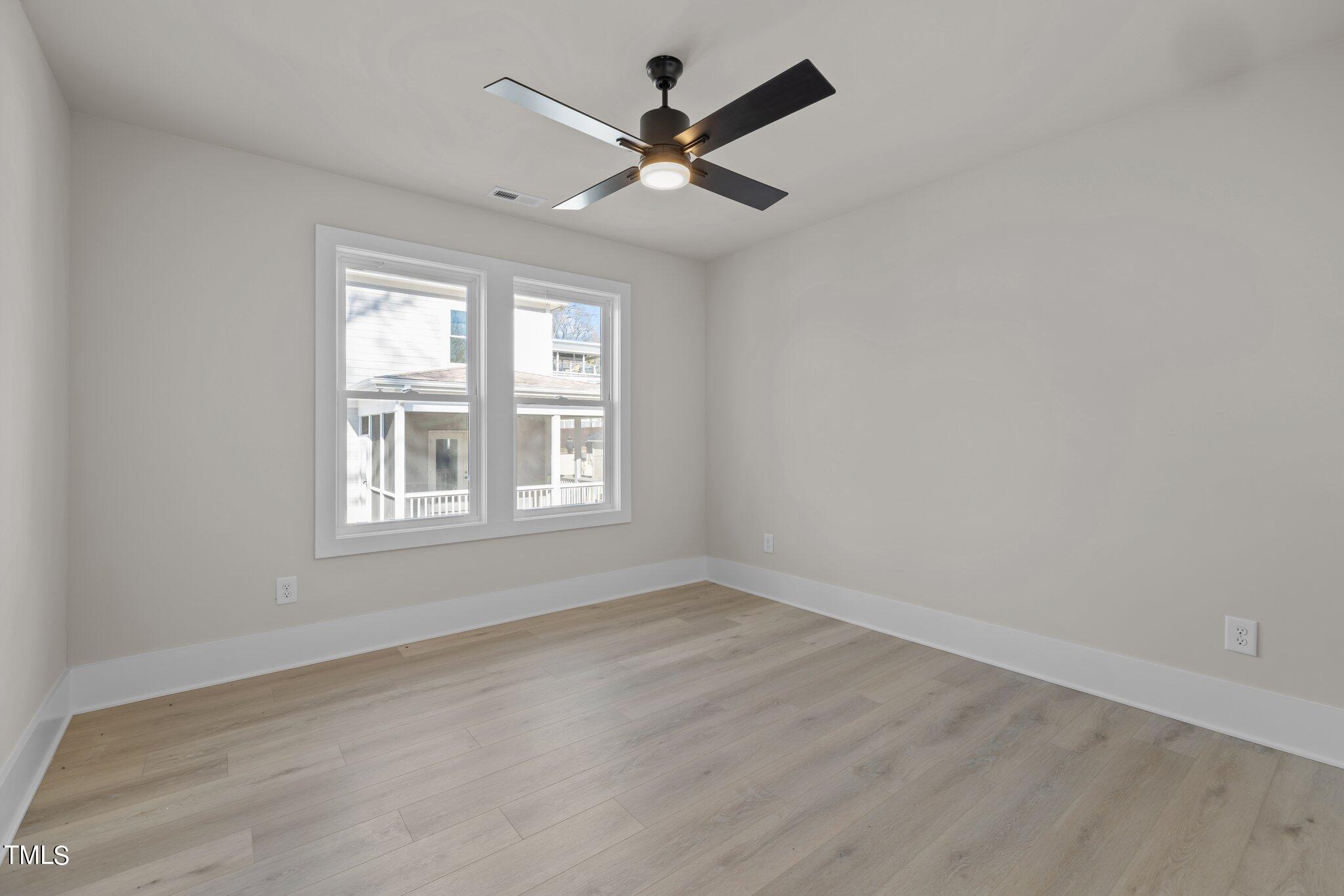 600 Bragg Street Raleigh, NC 27610 - Photo 48 of 68 an empty room with wooden floor and windows