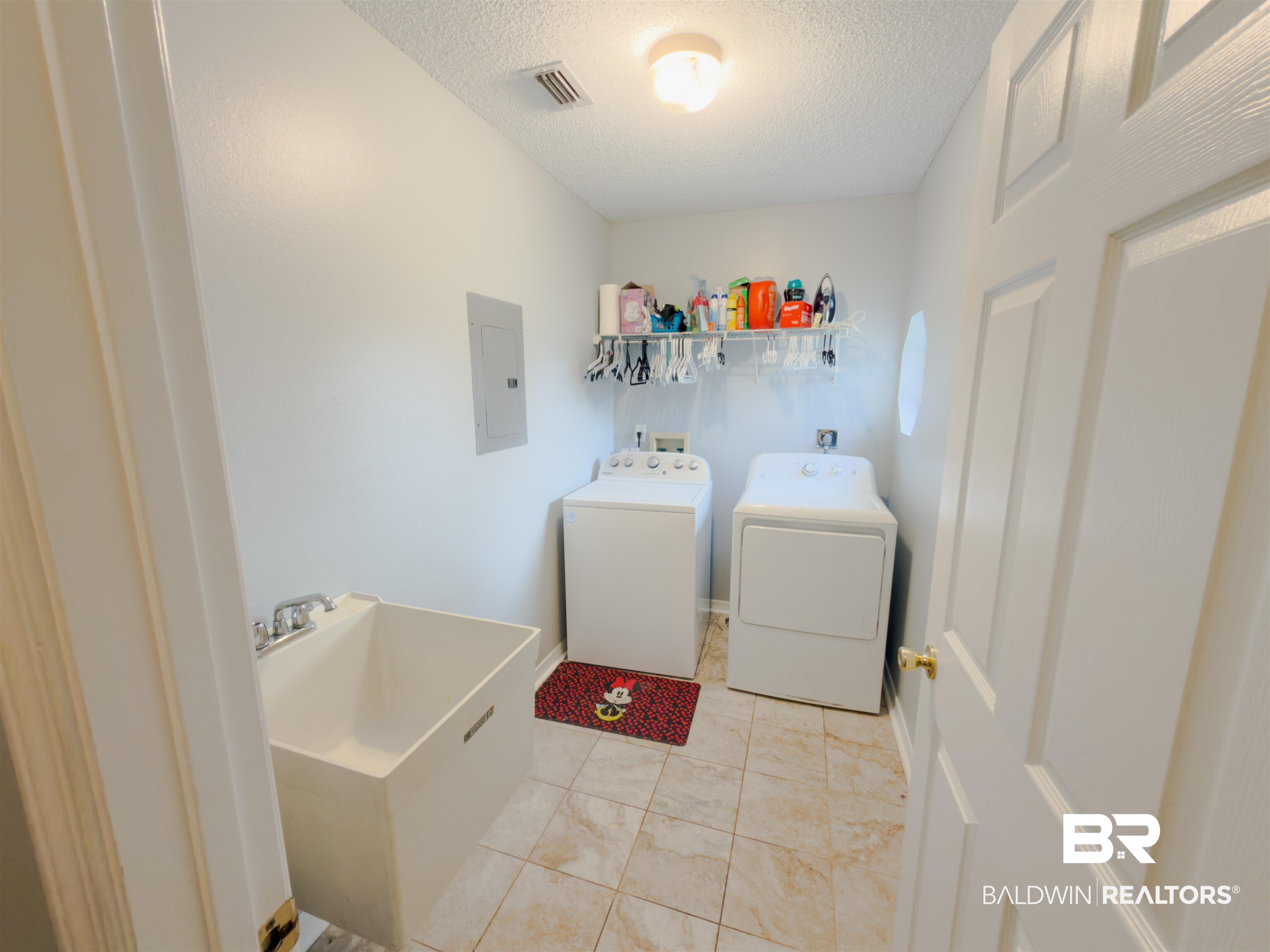 129 Pennbrooke Loop Foley, AL 36535 - Photo 23 of 44 Laundry room featuring electric panel, a textured ceiling, and washer and dryer