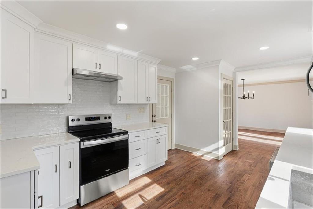 49 Apache Trail Cartersville, GA 30120 - Photo 21 of 52 a kitchen with stainless steel appliances white cabinets and wooden floor