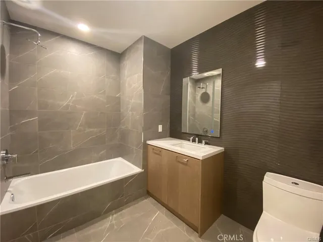 a bathroom with a sink a toilet and bathtub