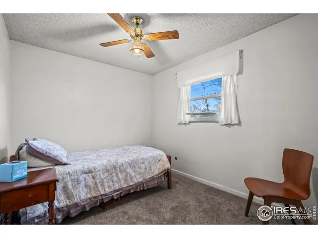 a bedroom with a bed and a chair