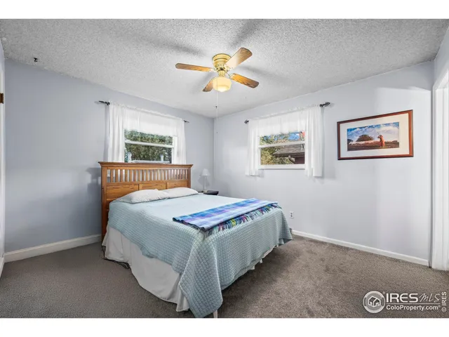 a bedroom with a bed and a painting on the wall