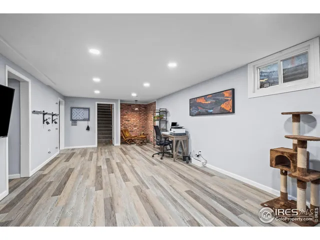 a view of a livingroom with furniture and a window