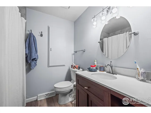 a bathroom with a sink vanity and toilet