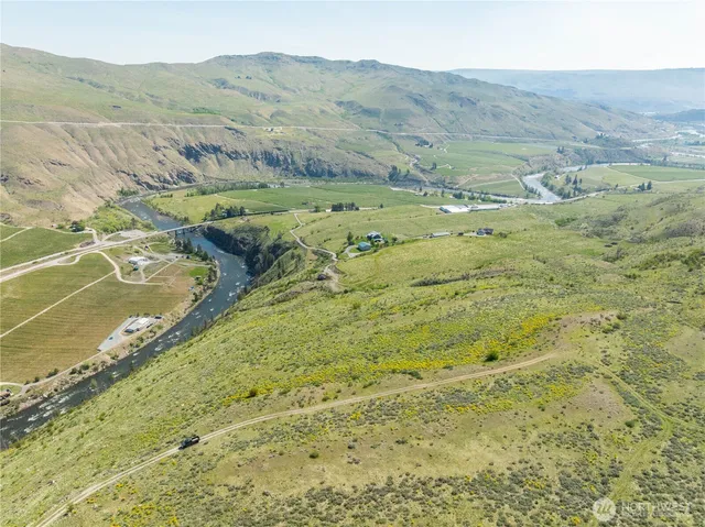 a view of a lush green hillside and houses