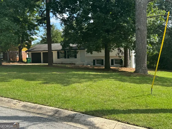 a house view with a sitting space and garden