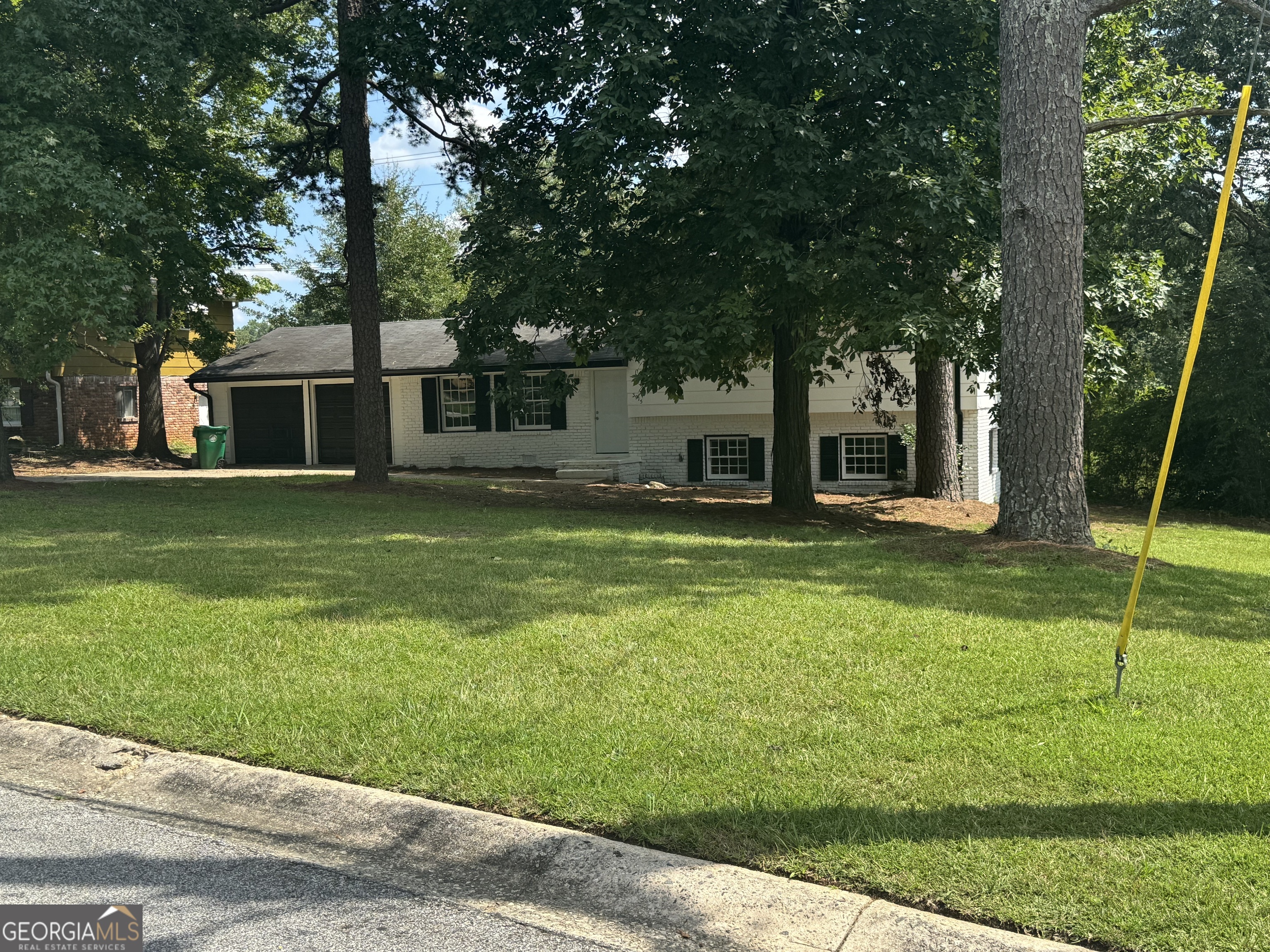 a house view with a sitting space and garden