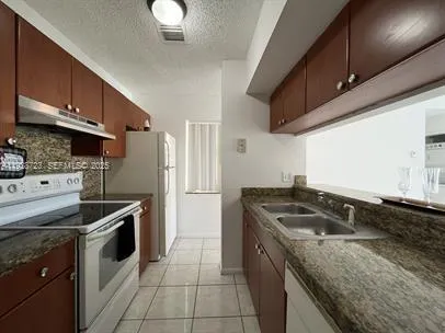 a kitchen that has a sink and a stove