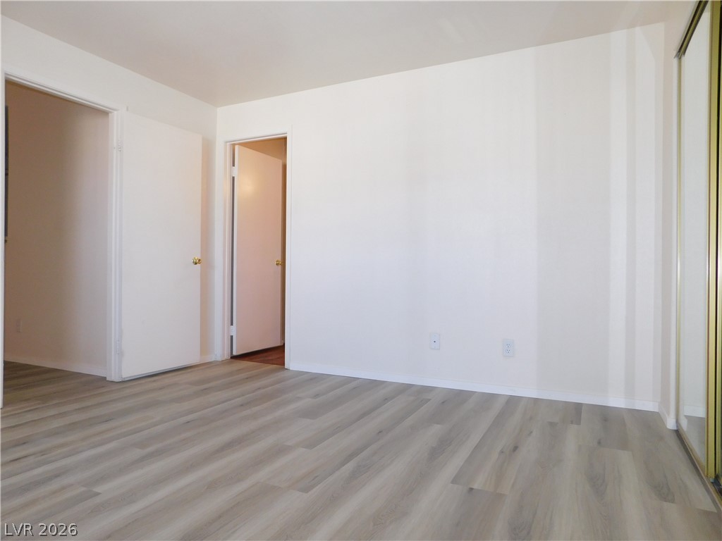 5221 South Lindell Road, Unit 202 Las Vegas, NV 89118 - Photo 12 of 28 Newly installed laminate flooring enhances this adaptable living space, ready for your personal touch.