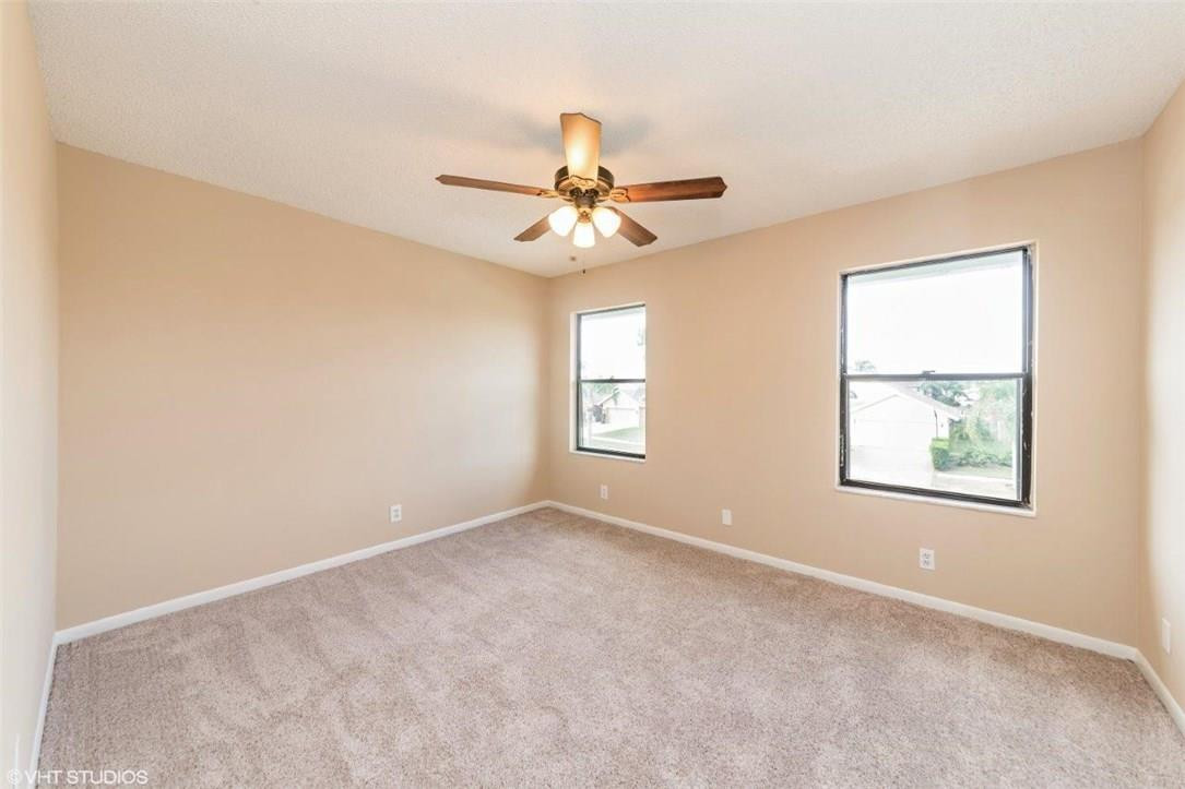 22494 Grouper Court Boca Raton, FL 33428 - Photo 12 of 22 an empty room with windows and fan