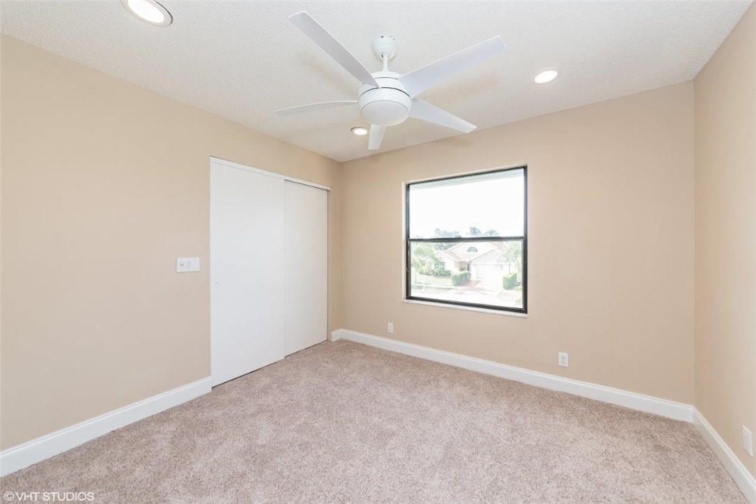 22494 Grouper Court Boca Raton, FL 33428 - Photo 13 of 22 an empty room with windows and ceiling fan