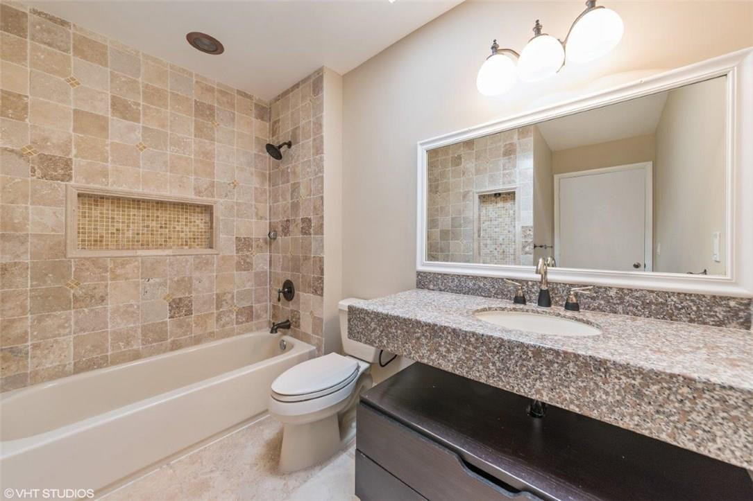 22494 Grouper Court Boca Raton, FL 33428 - Photo 14 of 22 a bathroom with a granite countertop bathtub sink vanity mirror and toilet