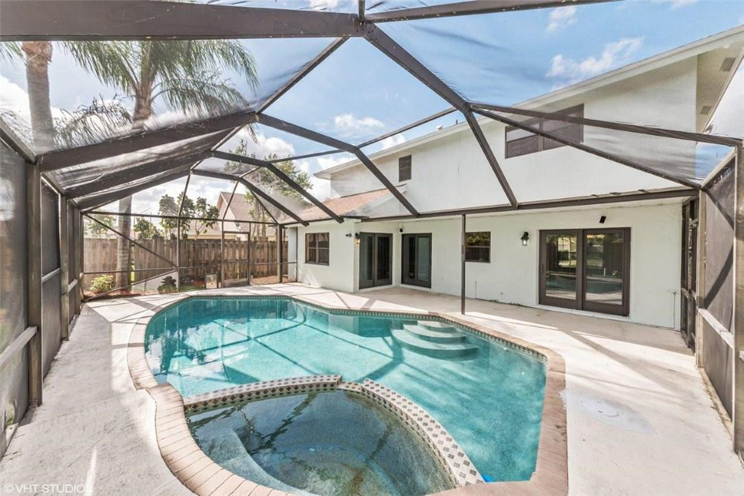 22494 Grouper Court Boca Raton, FL 33428 - Photo 19 of 22 a view of a house with a backyard porch and sitting area