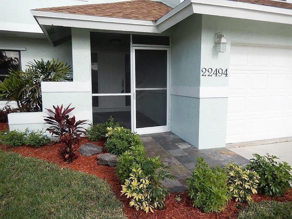 22494 Grouper Court Boca Raton, FL 33428 - Photo 2 of 22 a potted plant sitting in front of a house