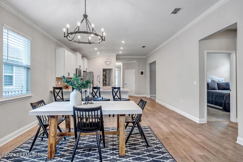 196 Creekmore Drive St. Augustine, FL 32092 - Photo 14 of 51 a view of a dining room with furniture window and wooden floor