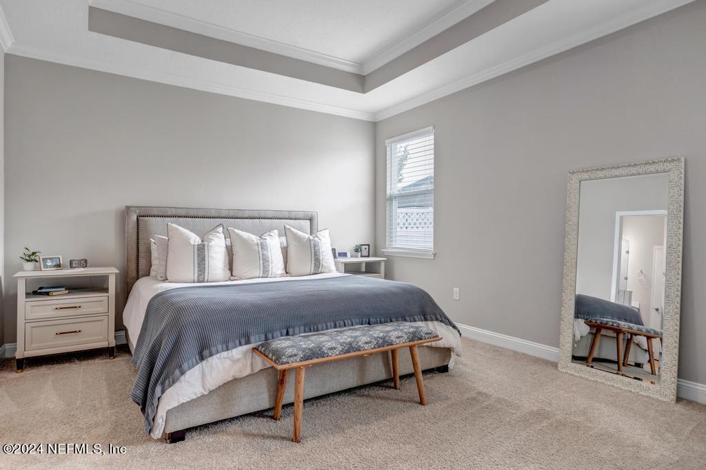 196 Creekmore Drive St. Augustine, FL 32092 - Photo 21 of 51 a bedroom with a bed and a lamp