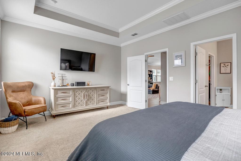 196 Creekmore Drive St. Augustine, FL 32092 - Photo 22 of 51 a bedroom with a bed and a flat screen television