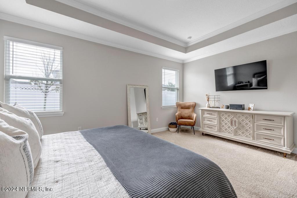 196 Creekmore Drive St. Augustine, FL 32092 - Photo 23 of 51 a bedroom with furniture and a flat screen tv