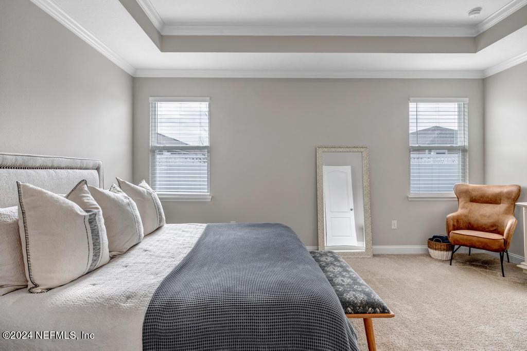 196 Creekmore Drive St. Augustine, FL 32092 - Photo 24 of 51 a bedroom with a bed and a couch