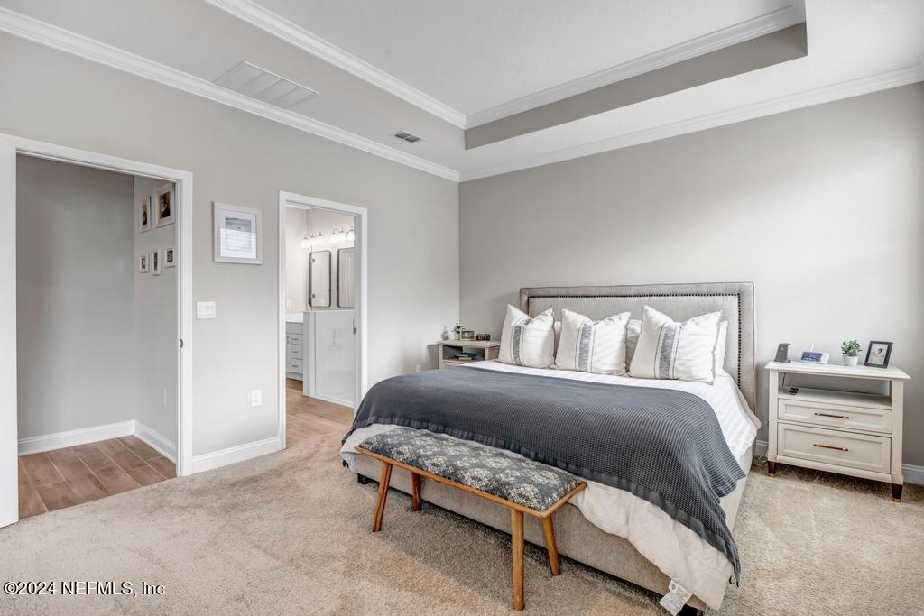 196 Creekmore Drive St. Augustine, FL 32092 - Photo 25 of 51 a bedroom with a bed and a cabinets