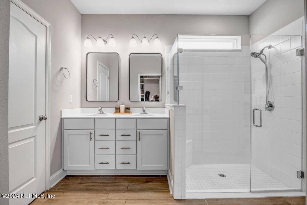 196 Creekmore Drive St. Augustine, FL 32092 - Photo 27 of 51 a bathroom with a double vanity sink mirror and shower