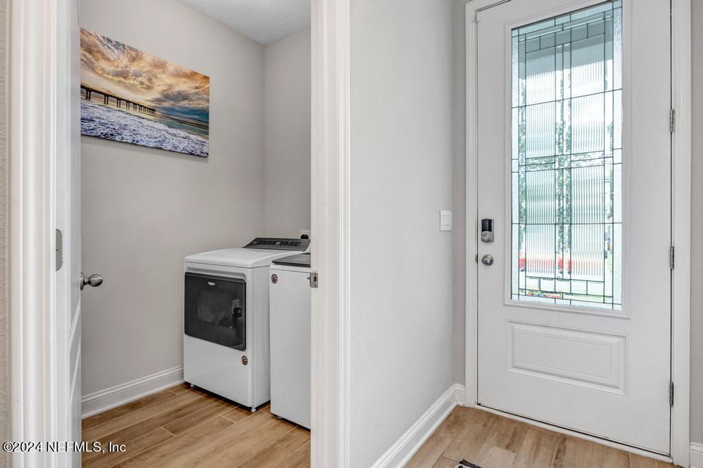 196 Creekmore Drive St. Augustine, FL 32092 - Photo 3 of 51 a view of a hallway with washer and dryer