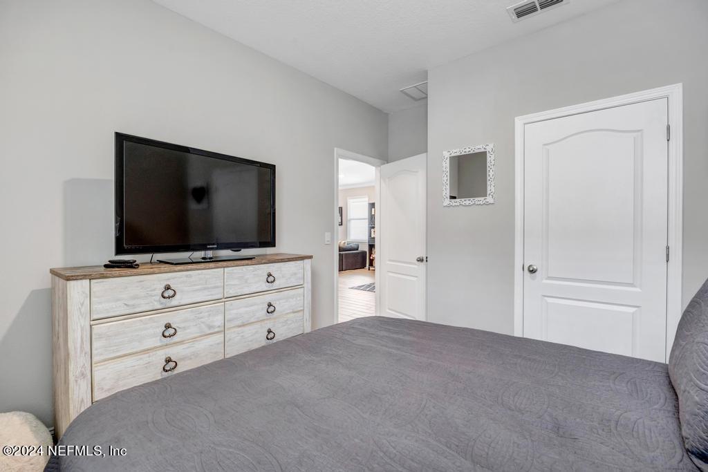 196 Creekmore Drive St. Augustine, FL 32092 - Photo 31 of 51 a living room with flat screen tv on dresser and a window