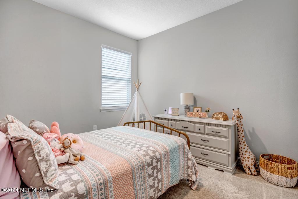 196 Creekmore Drive St. Augustine, FL 32092 - Photo 32 of 51 a bedroom with a bed and a window