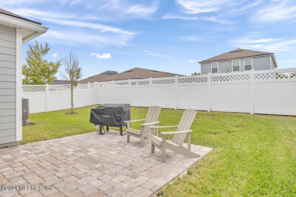 196 Creekmore Drive St. Augustine, FL 32092 - Photo 36 of 51 a view of a house with a backyard and a patio