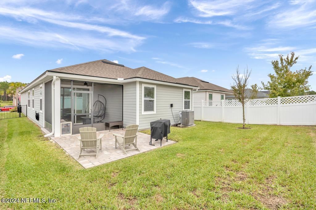 196 Creekmore Drive St. Augustine, FL 32092 - Photo 37 of 51 a backyard of a house with table and chairs